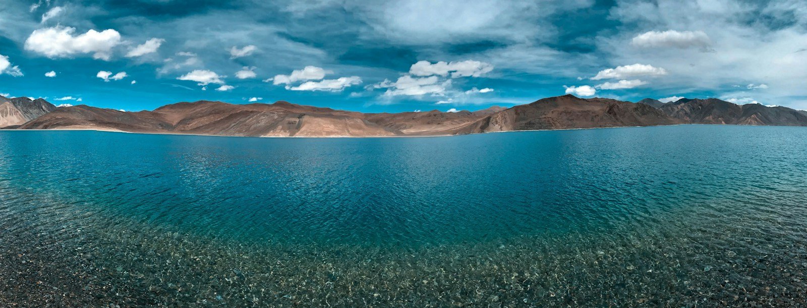 Blue waters of Pangong Lake beneath the mountains of Ladakh